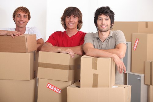 Moving team handling furniture and packing for removals in St Helier